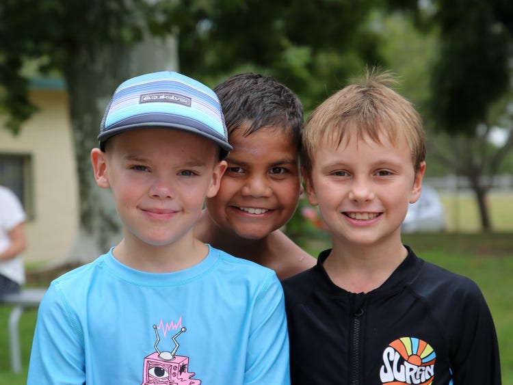 Three (3) students facing camera with cheeky smiles