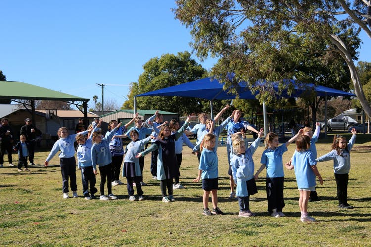 Students dance group out in the playground, performing.