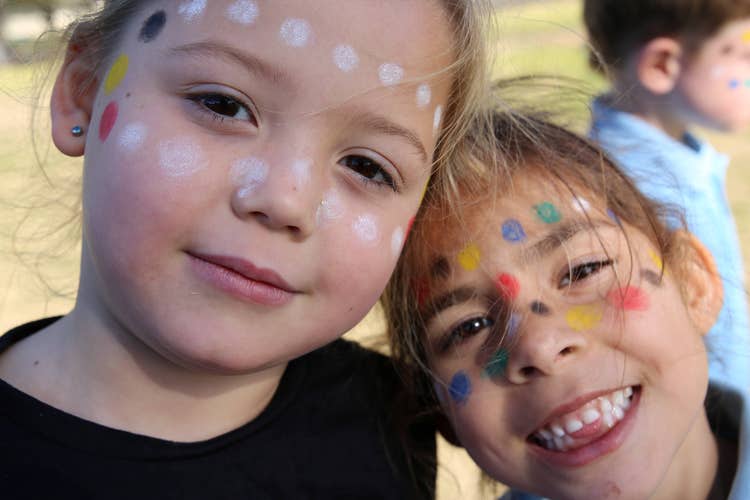 2 students with indigenous face painting